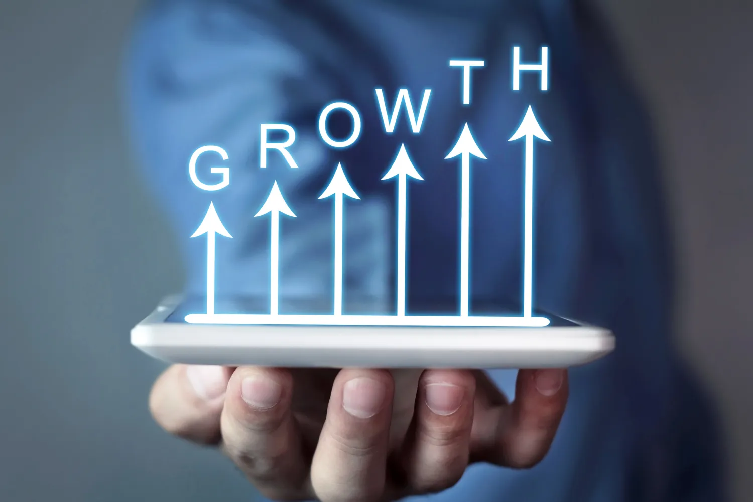 Businessman holding business growth graph.