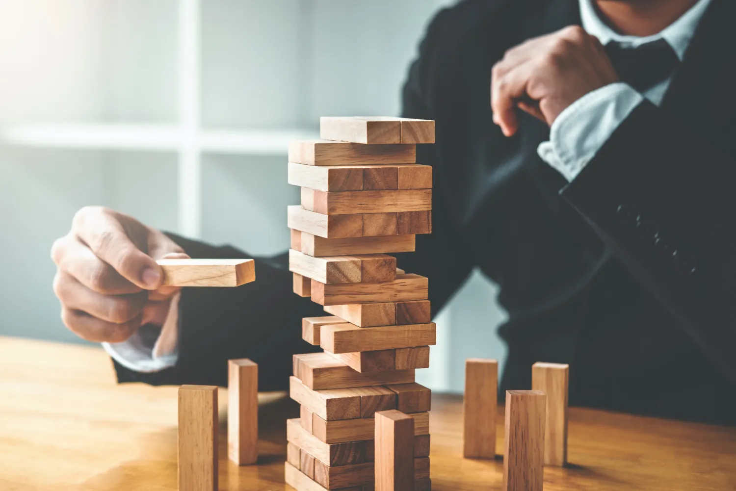 Businessman plan and strategy in business Domino Effect Leadership Management Solution concept